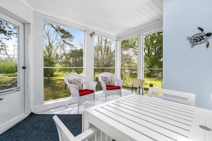 Creekside Cottage with Sunroom and Fire Pit - with Plenty of Outdoor Space Near Assateague Island in Chincoteague, VA - Chincoteague, Virginia - glamping.directory