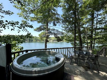 Charming Lakefront Cabin with Hot Tub and Beach Access near Traverse City, Michigan - glamping.directory