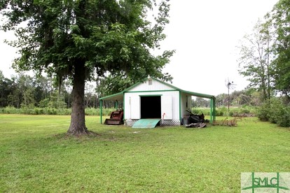 Quaint Cottage with Covered Dock on the Pond and Walking Trails in Georgia - Midway, Georgia - glamping.directory
