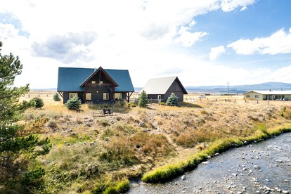 Remote Riverfront Cabin with Porch and Amazing Views in Montana - glamping.directory