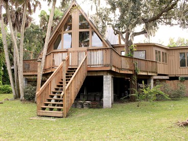 A-Frame Cabin Rental with Spacious Deck Overlooking the Cotee River, Florida - glamping.directory